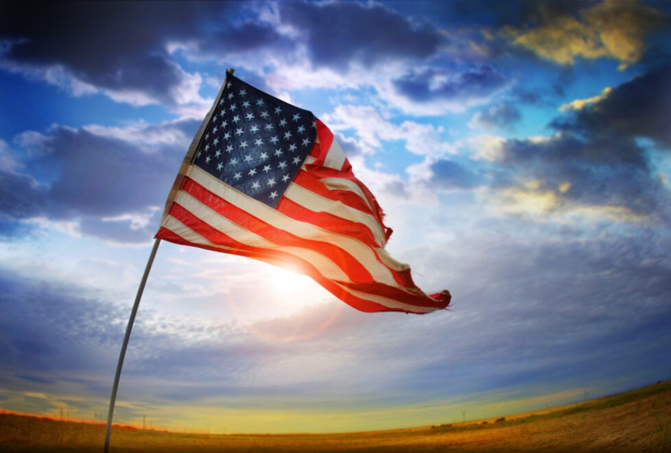 A flag is flying in the wind on a cloudy day. A flag is flying in the wind on a cloudy day.